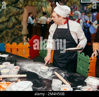 professional chef preparing pizza for the kids Stock Photo