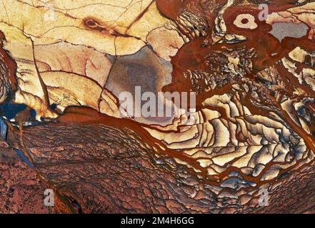 Backgrounds and textures: surface of beautiful brown and yellow decorative stone, natural abstract pattern of swirls, twirls, lines, cracks, spots and Stock Photo
