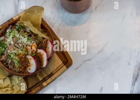 carne en su jugo mexican food, includes onion, radish, beef and corn