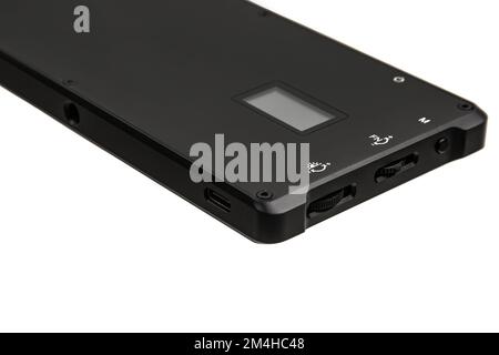 A small portable LED panel on the battery. Lighting device for photo and video filming. Isolate on a white background. Stock Photo