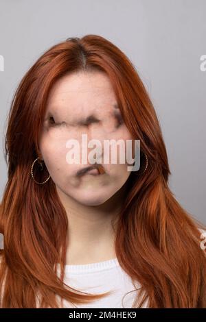 artificial intelligence error, disfigured face of a girl due to image processing technical problems. False virtual reality due to a processing bug Stock Photo