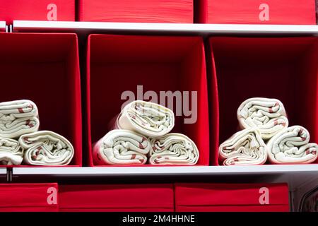White towels in red boxes on store shelves Stock Photo