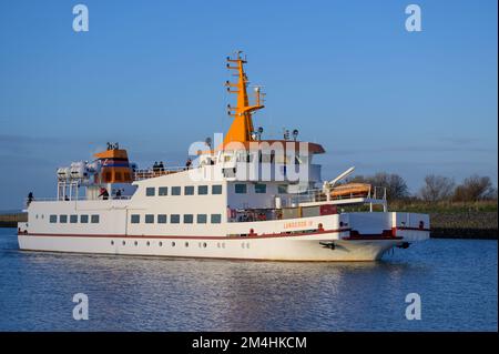 BENSERSIEL, GERMANY - NOVEMBER 25, 2022: The ferry Langeoog IV arrives in port Stock Photo