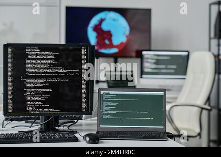 Close-up of computer monitor with codes on the screen standing on table of developer Stock Photo