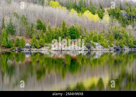 Early spring reflections in Simon Lake, Greater Sudbury, Ontario, Canada Stock Photo