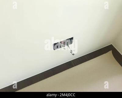 An electric work of wall outlet with cables and sockets on the white wall, A field of construction work Stock Photo