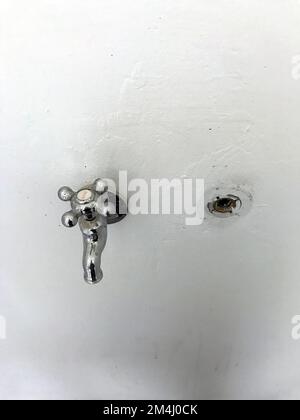 The single tap on the white wall Stock Photo
