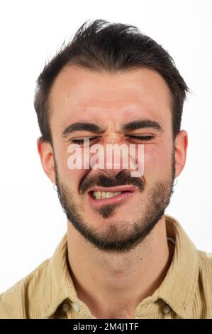 funny expressions of a young caucasian man, grimace of a boy isolated on white background Stock Photo