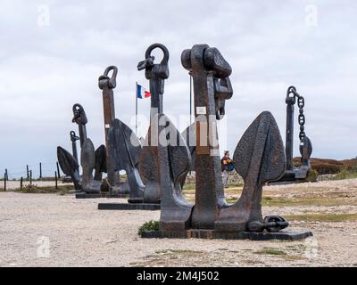 Exposed black historic anchors in old fortification, bunker, La Batterie de Kerbonn Museum (Museum commemorating the Battle of the Atlantic), near Stock Photo