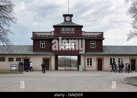 Visitors at the gate to the camp, main watchtower at the former beech forest concentration camp, Ettersberg near Weimar, Germany Stock Photo