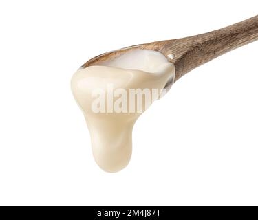 Mayonnaise sauce in a wooden spoon on a white background Stock Photo