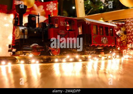 Berlin, Germany - December 21, 2022: Christmas train amid twinkling lights and Christmas decorations. Stock Photo