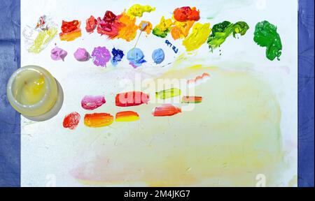 Artistic palette with multi-colored paints on white background. Stock Photo