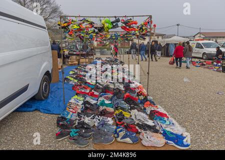 Belgrade, Serbia - October 29, 2022: Second Hand Colourful Cleats Soccer Football Sports Shoes Hanging by Laces at Flea Market. Stock Photo