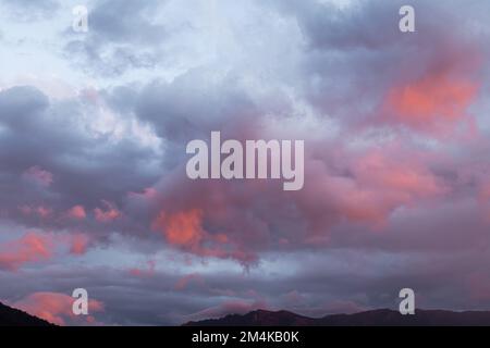 Storm clouds with amazing colours reverse sunset. Stock Photo