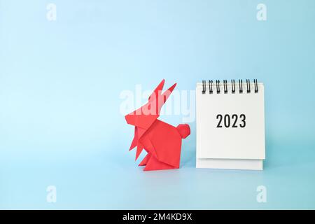 Chinese new year 2023 year of the rabbit concept. 2023 desk calendar with red rabbit origami. Stock Photo