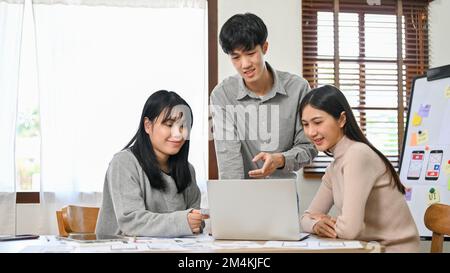 Group of millennial Asian website and mobile application developers startup are in the meeting, discussing and brainstorming on their new project. Stock Photo