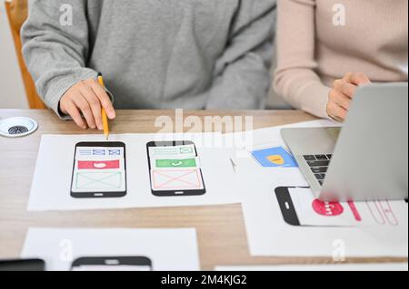 close-up image, Team of professional mobile application developers checking and testing their new prototype in the meeting. Stock Photo