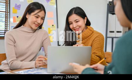 Smart millennials Asian UX developer and UI designer are in the meeting, planning and brainstorming their new mobile application design. Stock Photo