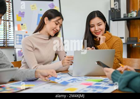A professional female graphic designer discussing and brainstorming a new prototype with her team. testing and iteration, analysis and development, UX Stock Photo