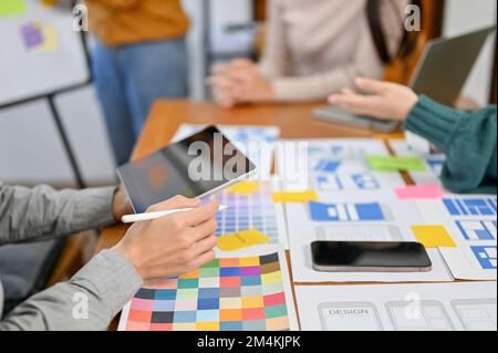 close-up image, A team of professional website and mobile application designers are in the meeting, brainstorming user interface design. UX UI Stock Photo