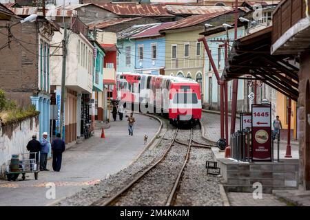 A passenger train moves through the Andean highland town of Alausi in Ecuador. The town is the starting point for the famous Devil's Nose railway. Stock Photo