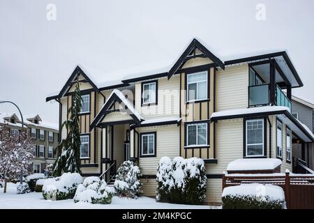Nice neighborhood in cold,chilly and frosty winter time covered with snow . Vancouver, Canada.Big luxury house in snowfall cold. Nice and comfortable Stock Photo