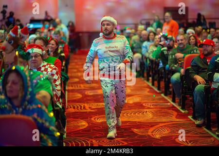 Bensalem, United States. 21st Dec, 2022. A contestant walks to the stage as part of WMMR Radio's Ugly Christmas Sweater contest Wednesday, December 21, 2022 at PARX Xcite Center in Bensalem, Pennsylvania. The winner of the contest receives a year supply of beer. Credit: William Thomas Cain/Alamy Live News Stock Photo