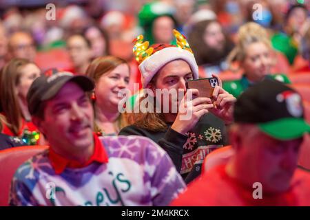 Bensalem, United States. 21st Dec, 2022. A man makes pictures as part of WMMR Radio's Ugly Christmas Sweater contest Wednesday, December 21, 2022 at PARX Xcite Center in Bensalem, Pennsylvania. The winner of the contest receives a year supply of beer. Credit: William Thomas Cain/Alamy Live News Stock Photo