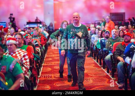 Bensalem, United States. 21st Dec, 2022. Contestants walk to the stage as part of WMMR Radio's Ugly Christmas Sweater contest Wednesday, December 21, 2022 at PARX Xcite Center in Bensalem, Pennsylvania. The winner of the contest receives a year supply of beer. Credit: William Thomas Cain/Alamy Live News Stock Photo