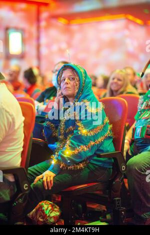 Bensalem, United States. 21st Dec, 2022. A woman wears a tree costume as part of WMMR Radio's Ugly Christmas Sweater contest Wednesday, December 21, 2022 at PARX Xcite Center in Bensalem, Pennsylvania. The winner of the contest receives a year supply of beer. Credit: William Thomas Cain/Alamy Live News Stock Photo