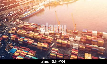 Containers in cargo freight port, aerial view. Industrial harbor, global transportation and international logistic business concept. Stock Photo