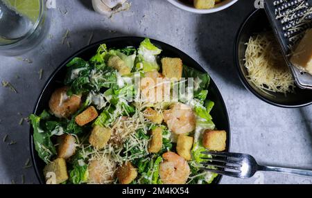 close up of Cesar salad with grilled shrimp, croutons and parmesan cheese Stock Photo