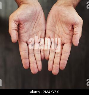 Your hands shows that you are healthy. Studio shot of an unrecognizable persons open hands shown against a dark background. Stock Photo