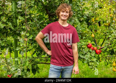 Cheerful Caucasian gardener working in the garden Stock Photo