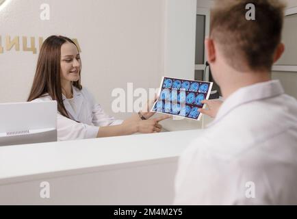 In the medical clinic there were radiograph doctors discussing the results of computed tomography of the brain Stock Photo