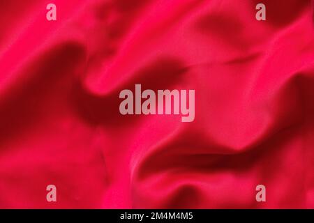 red silk crumpled close-up as background, silk dress Stock Photo