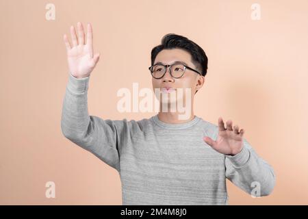 Portrait of young businessman pressing a button on an imaginary screen. Stock Photo