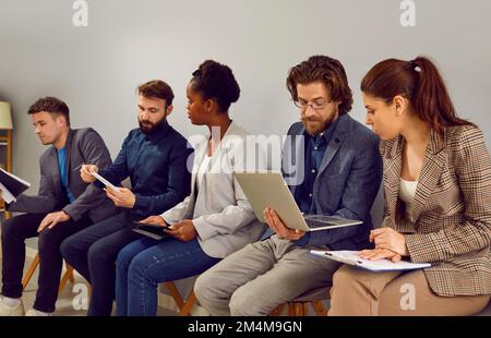 Colleagues talk to each other discussing work issues and information heard during business seminar. Stock Photo