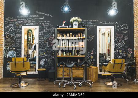 Modern hair salon interior. Amazing design of haircut area with big mirror and comfortable chairs. High quality photo Stock Photo