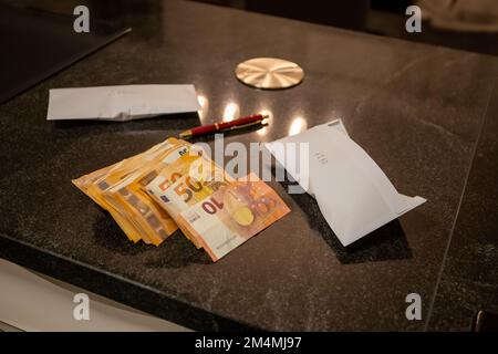 50 Euro and 10 Euro banknotes on a stone kitchen table with envelopes and ballpoint pen, fruit bowl in the background. High quality photo Stock Photo