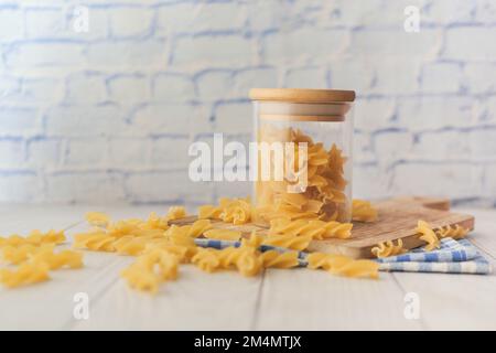 dry pasta noodles in a jar on table  Stock Photo