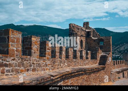 Ancient broken sandstone wall and ble sky. Stock Photo