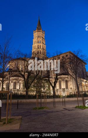 Vertical landscape view of historic landmark St Sernin basilica illuminated in evening, Toulouse, France Stock Photo