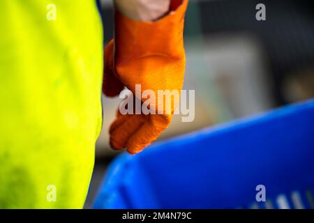 fisherman wearing waterproof clothes and gloves on a fishing boat in australia in summer Stock Photo