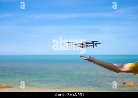 A guy launches from the arm of a prone on the seashore. Stock Photo
