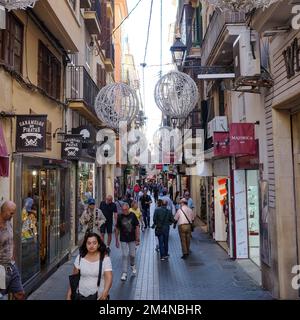 Palma de Mallorca, Spain - 7 Nov 2022: Pedestrians on the Carrer de Colom shopping street in Palma old town Stock Photo
