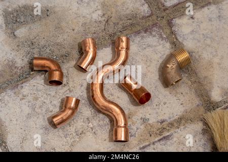 Copper fittings close-up on the concrete floor Stock Photo