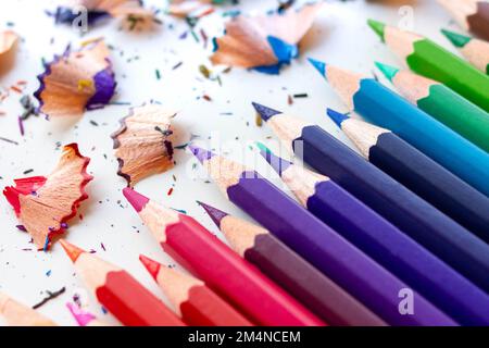 Close up crayons - color pencils isolated with multicolor pencil shavings. Horizontal with white background Stock Photo