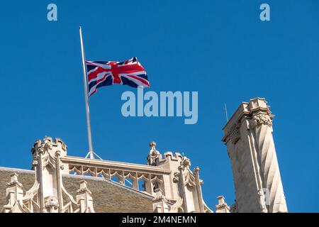 London- September 2022: British union flag flying at half mast in respect to the passing of Queen Elizabeth II Stock Photo